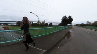 Crossdresser flashing on a highway bridge