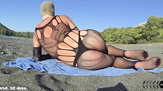 nylondelux bodysuit on public beach