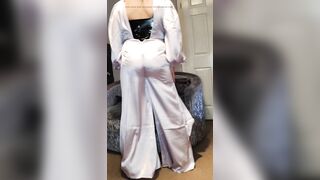 Sexy crossdresser is glamorous white satin jumpsuit