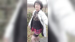 Crossdresser takes a walk on a windy lane