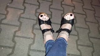 a crossdresser with astonishing feet walks on the street in high heel wedges and taut jeans and tempts boys