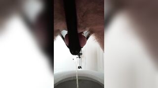 Pissing throughout pants in a chastity cage clothed in underware