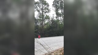 Crossdress walk outdoors by traffic.