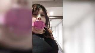 Sissy Kelli walks a hotel corridor wearing a shlong gag
