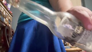 Maritza screwing a bottle