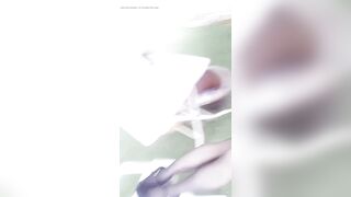 Youthful oriental beauty in aged outfit and ebony hose walks throughout apartment garden