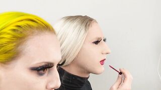Crossdresser and Woman Putting on Lipliner and Lipstick