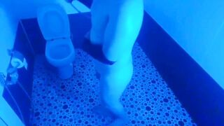 Playful sissy hiding face behind stuffed teddy bear