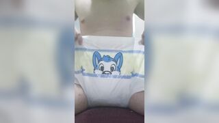 Pissing on an open diaper then puting it on